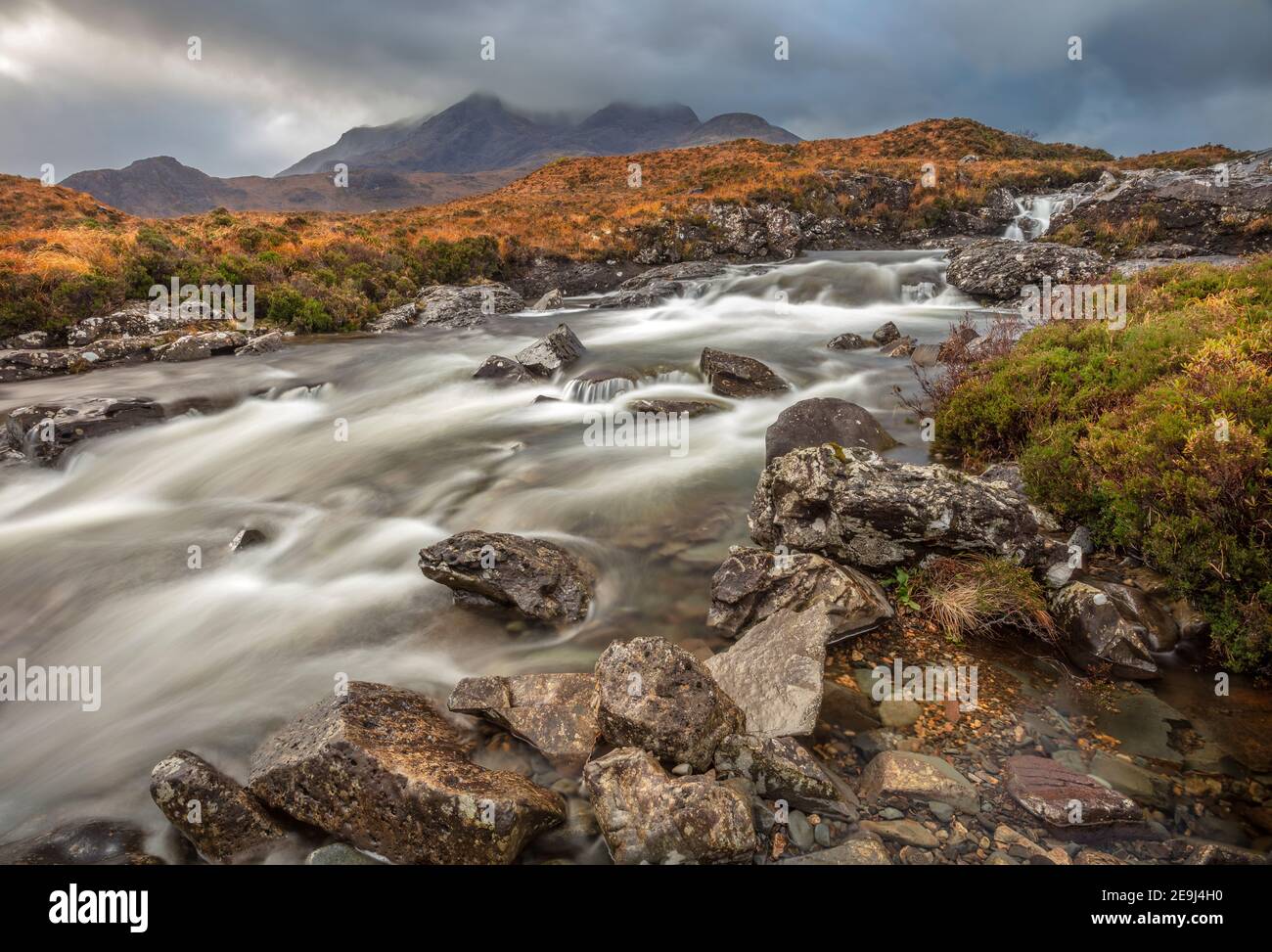 Isle of Skye, Scotland: Rushing waters of the River Sligachan with breaking light on the Black Cuillin Mountains in the distance Stock Photo