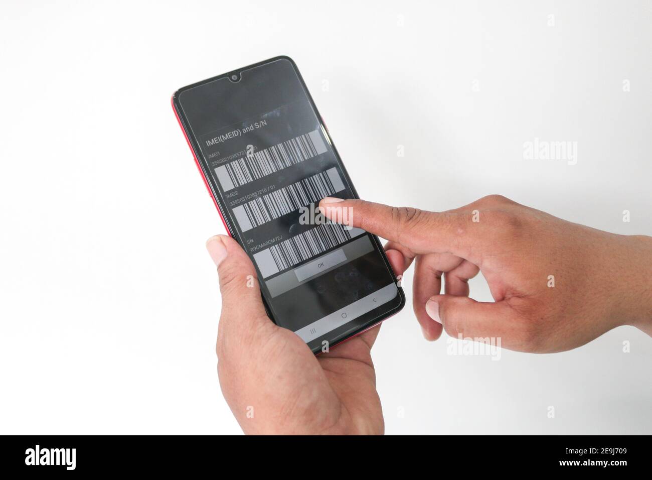 Detail photo of imei code on the mobile phone screen in hand isolated ...