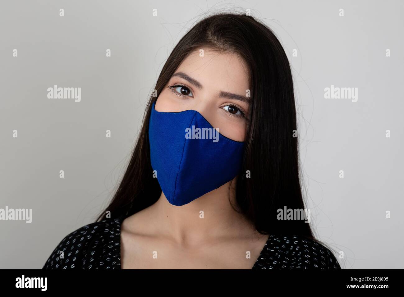 Image of a pretty young girl wearing Covid 19 protection mask and ...