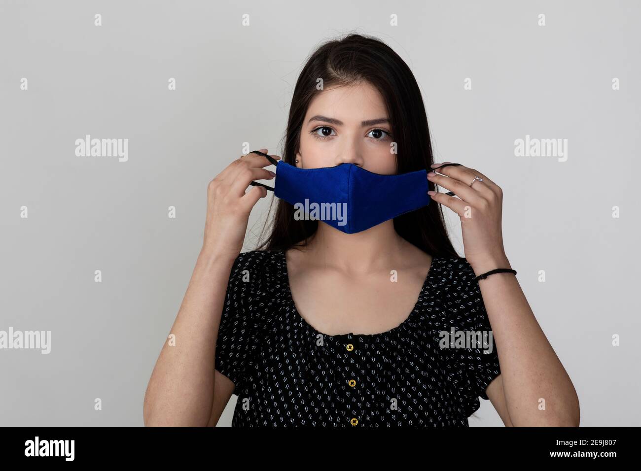 Image of a pretty young girl wearing Covid 19 protection mask and ...