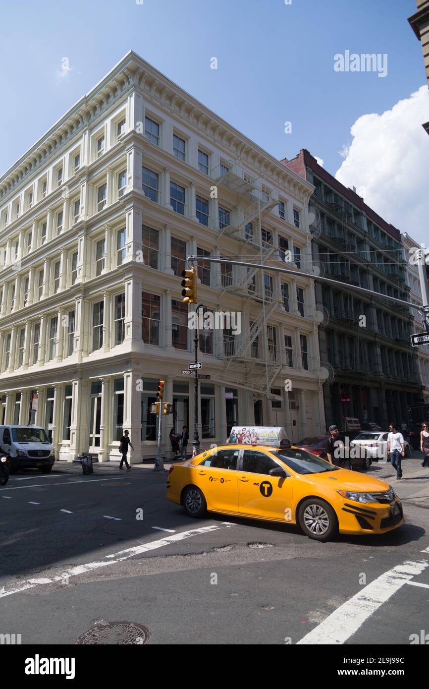 New York City Taxi Cab and Cast Iron Building in Soho Stock Photo