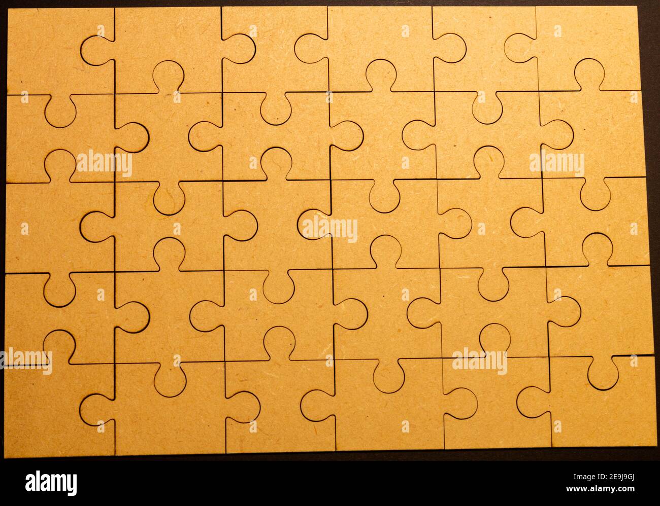 Tow view picture of a whole brown puzzle. Jigsaw as a graphic element
