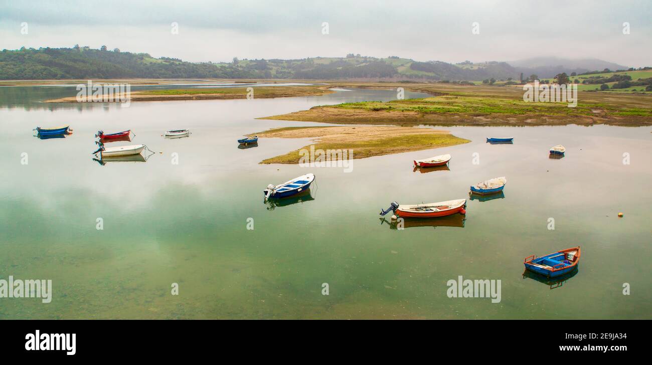 Fishing boat in the estuary of San Vicente de la Barquera. Between Asturias and Cantabria. Spain. Panoramic photography on the coastline Stock Photo