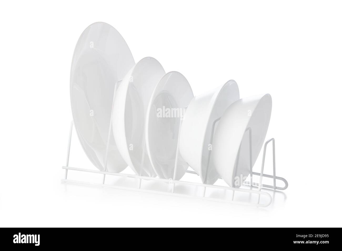 Set of white ceramic dishware on drainer Stock Photo