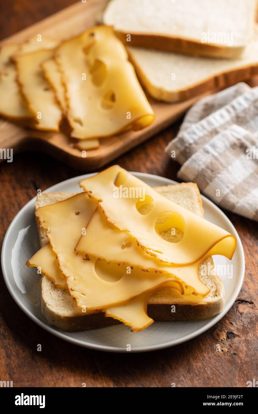 Sandwich bread with hard cheese on plate. Stock Photo