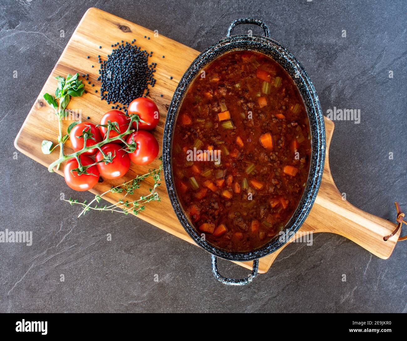 minced meat stew with beluga lentils and vegetables in a spicy tomato sauce served in a pot from above Stock Photo