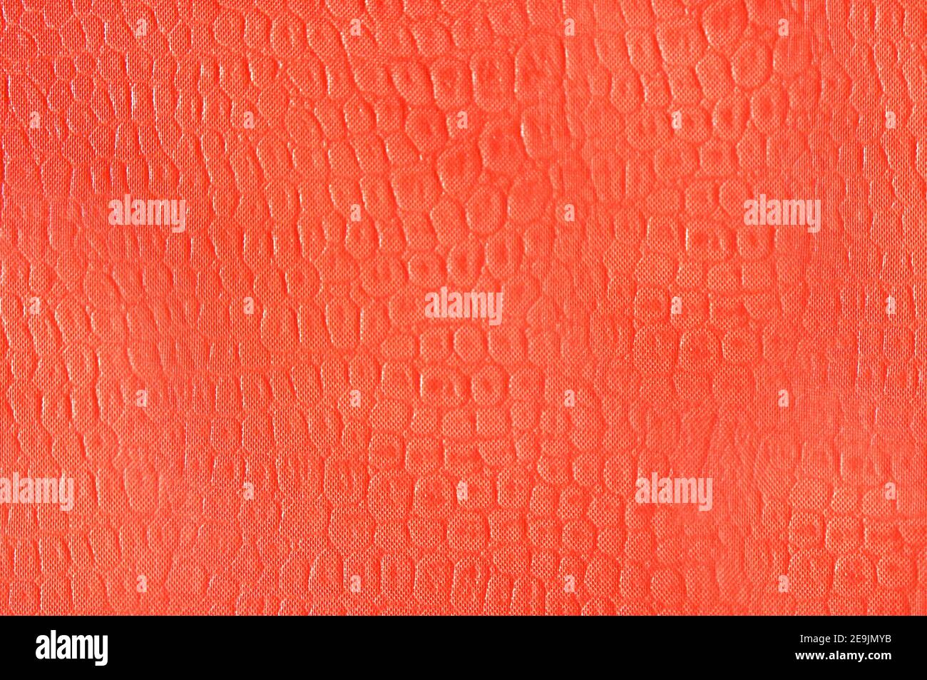 Artificial leather imitation snakeskin orange color.Texture or background Stock Photo