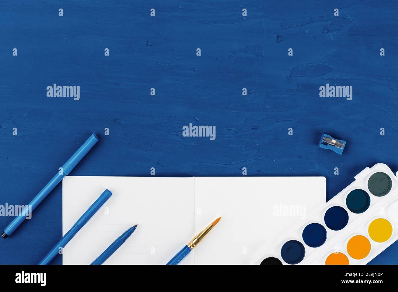 Blue paint brushes on classic blue background, view from above Stock ...