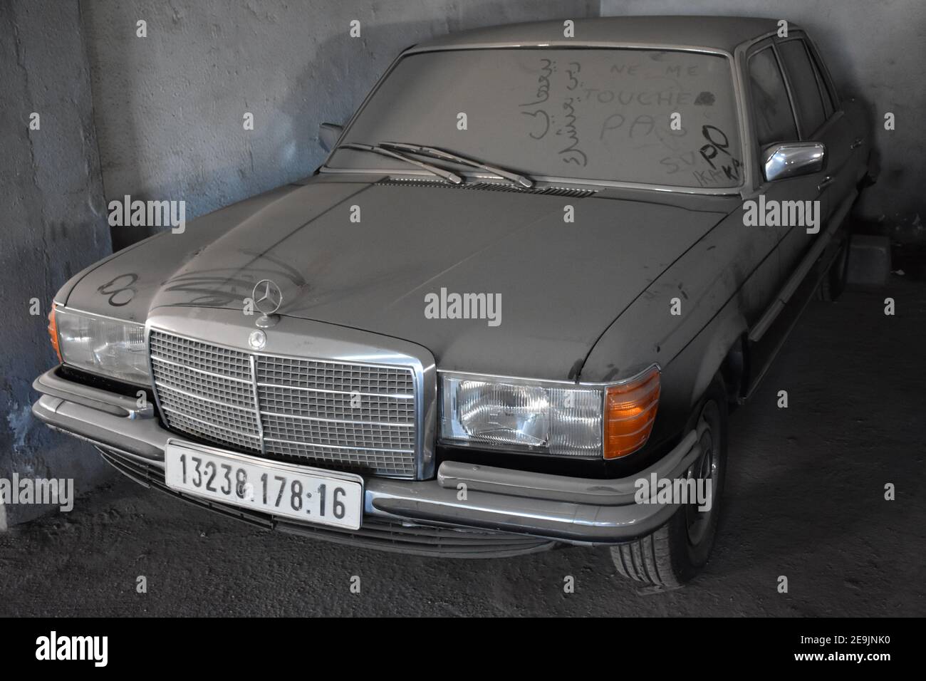 Dusty forgotten classic mercedes-benz w201 in garage in Algiers, Algeria Stock Photo