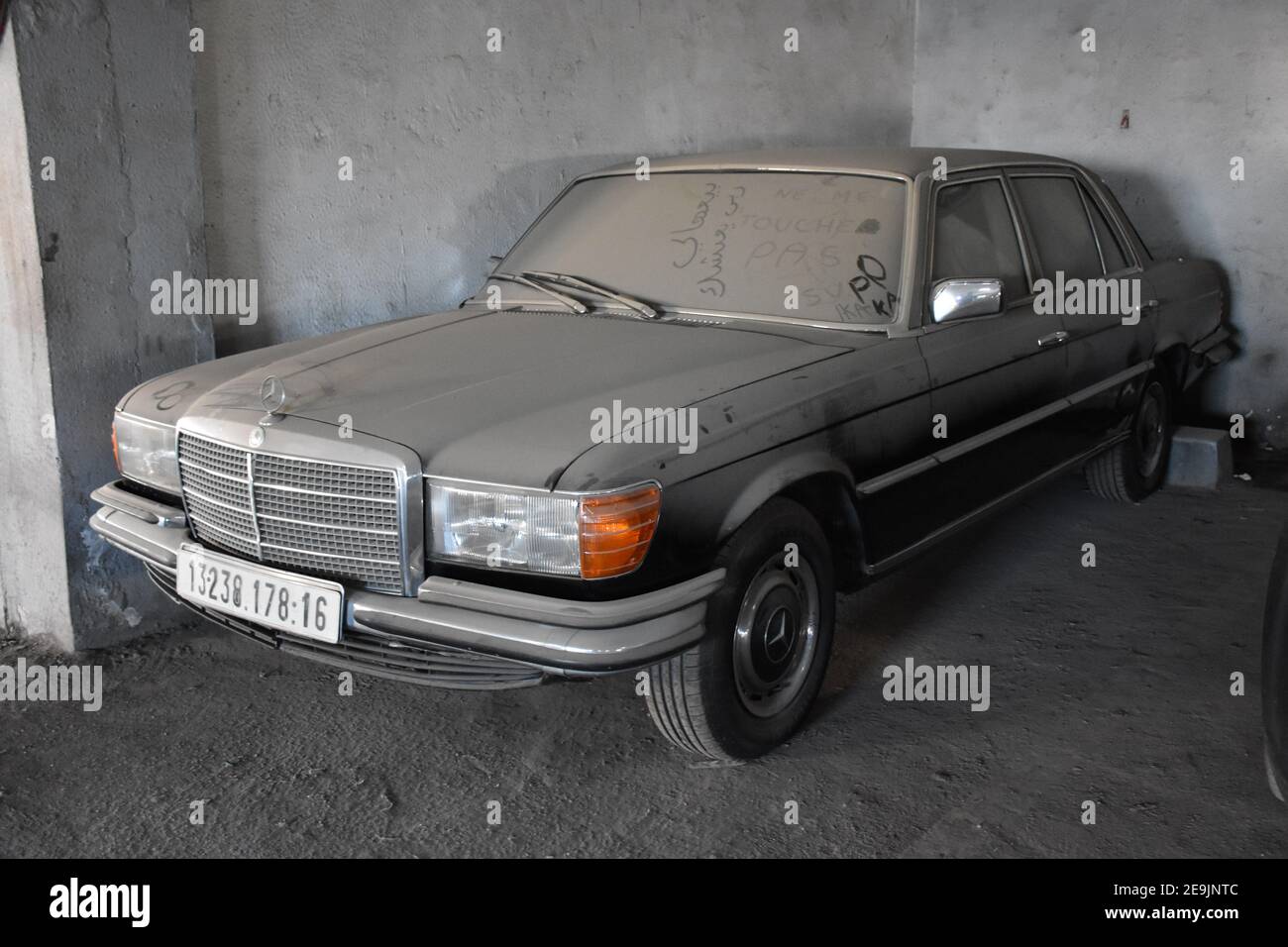Dusty forgotten classic mercedes-benz w201 in garage in Algiers, Algeria Stock Photo