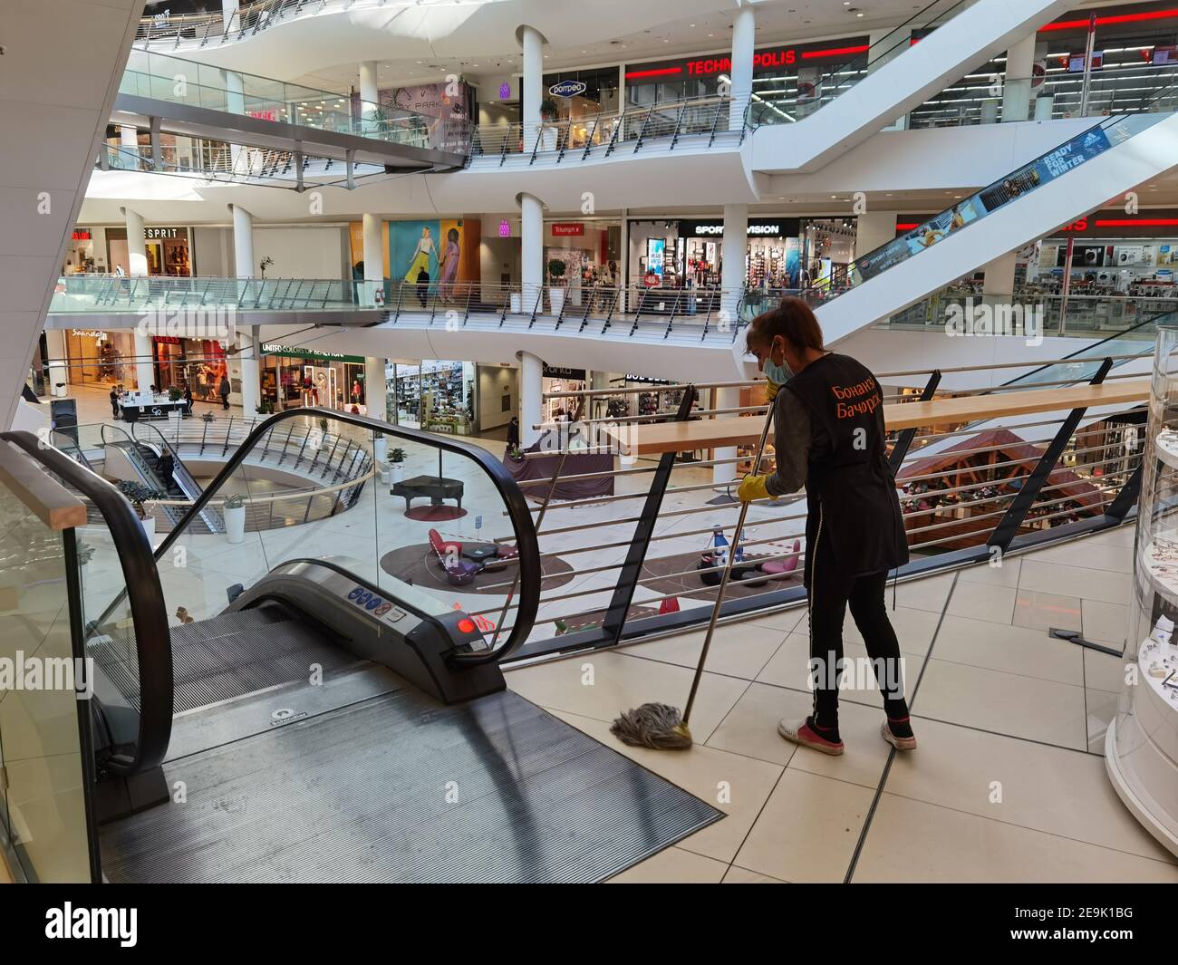 Sofia, Bulgaria - Feb 1 2021: A woman in protective mask is cleaning the  floor at Serdika shopping center preparing the center for visitors on the  re Stock Photo - Alamy