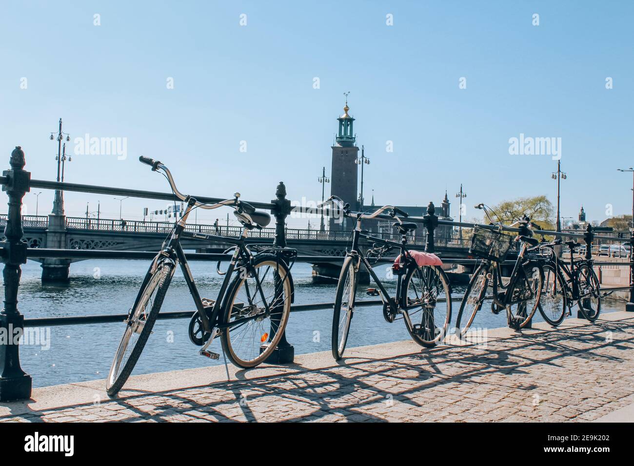 Stockholm, Sweden - May 1, 2019 : Scenic sunny day panorama of city quay with bicycles and City Hall, The Old Town in Stockholm. City tour concept and Stock Photo