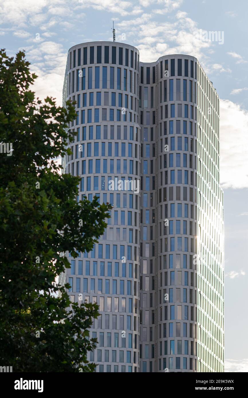 Facade of skyscraper, modern architecture rounded shape with cloudy sky, Christoph Langhof, city center, financial district, Breitscheidplatz, Berlin Stock Photo