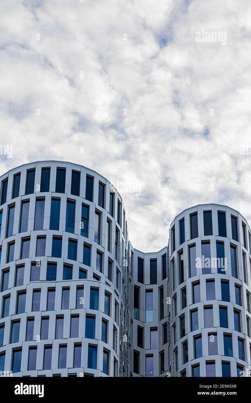 Glass facade, modern architecture rounded shape with cloudy sky, city center, financial district, Breitscheidplatz, Ku'damm, Berlin Stock Photo