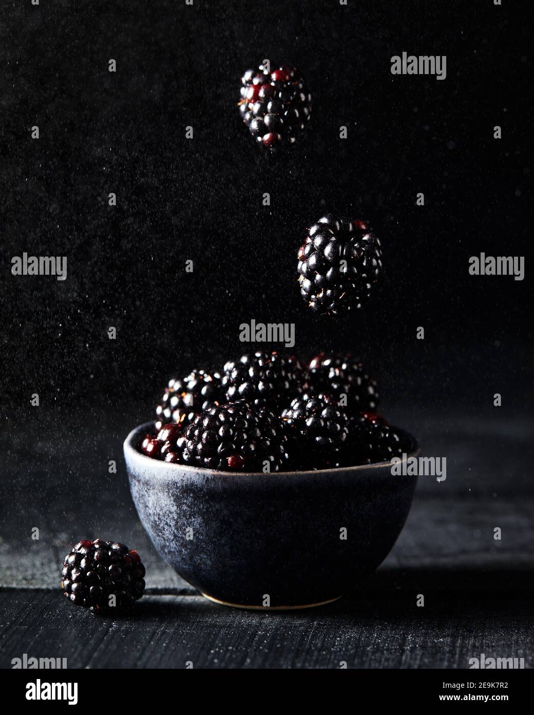 Fresh blackberry levitation on dark black background close up Stock Photo