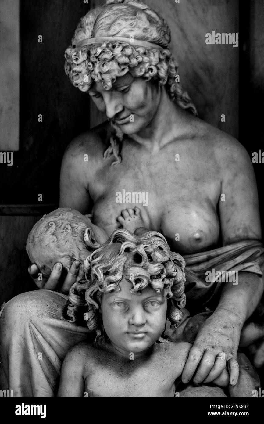 Statue of Breastfeeding Woman Children in Artistic Black and White Framework Stock Photo
