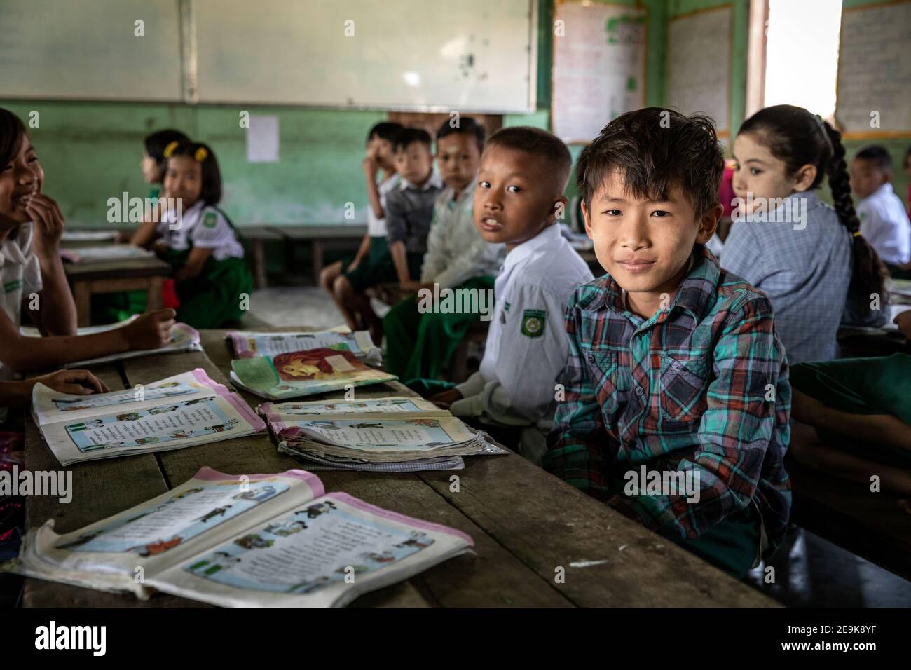 The orphans living in the Shatapru Education Boarder orphanage in Myikyina in Northern Myanmar attend classes in the government school. Stock Photo