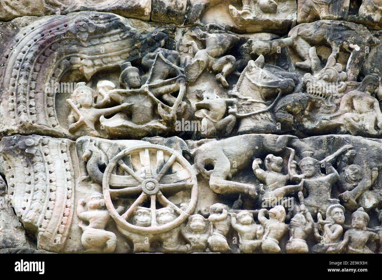 Ancient Khmer bas relief carving showing the god Rama (Vishnu) firing