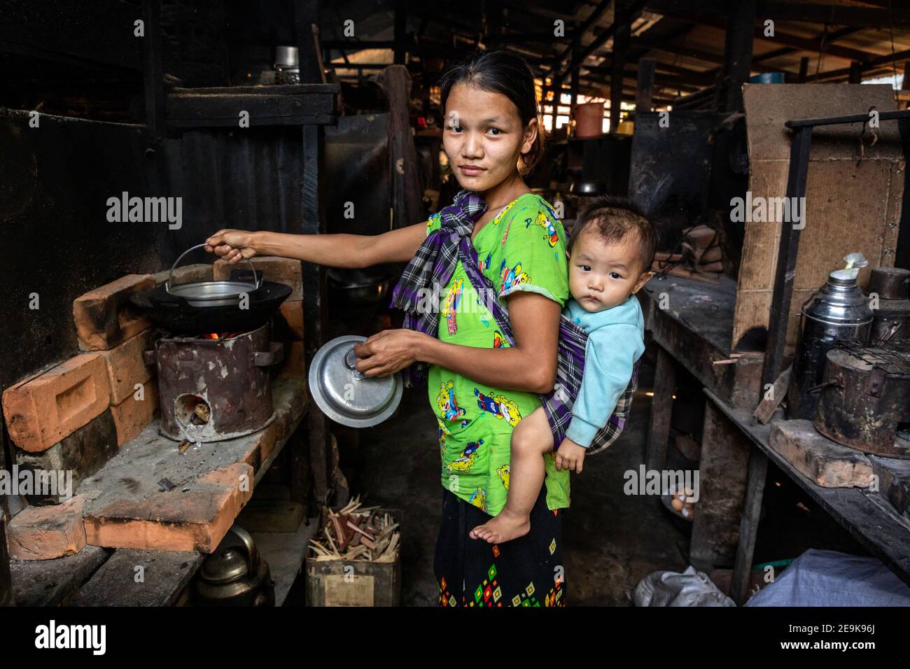 Daily life of the refugees in Shatapru IDP refugee camp in Myikyina, Myanmar. Each family has a room in the poor huts. Stock Photo