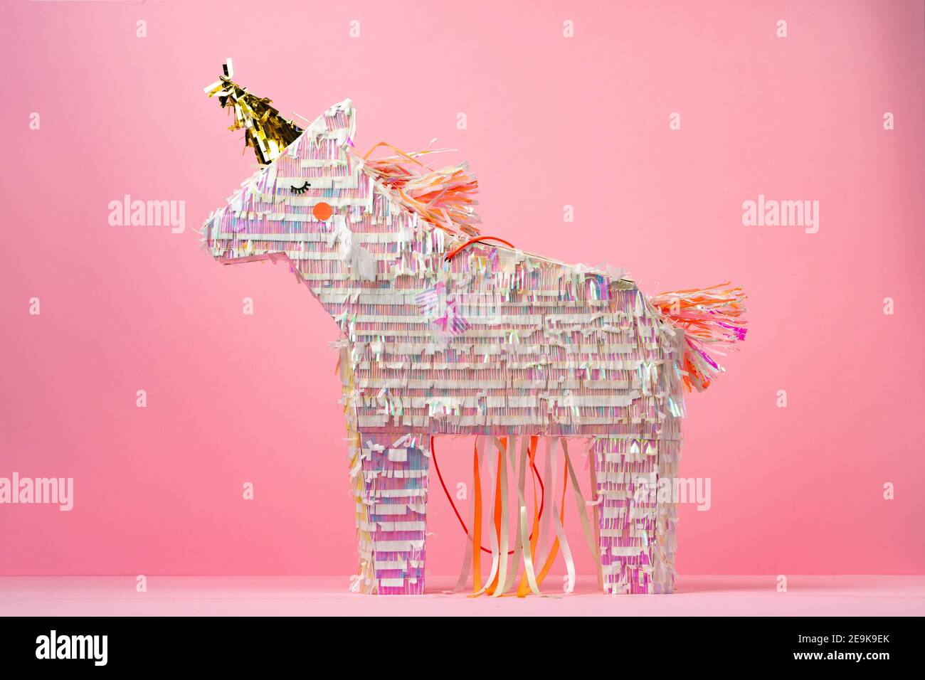 Unicorn pinata for kids party on pink background Stock Photo - Alamy