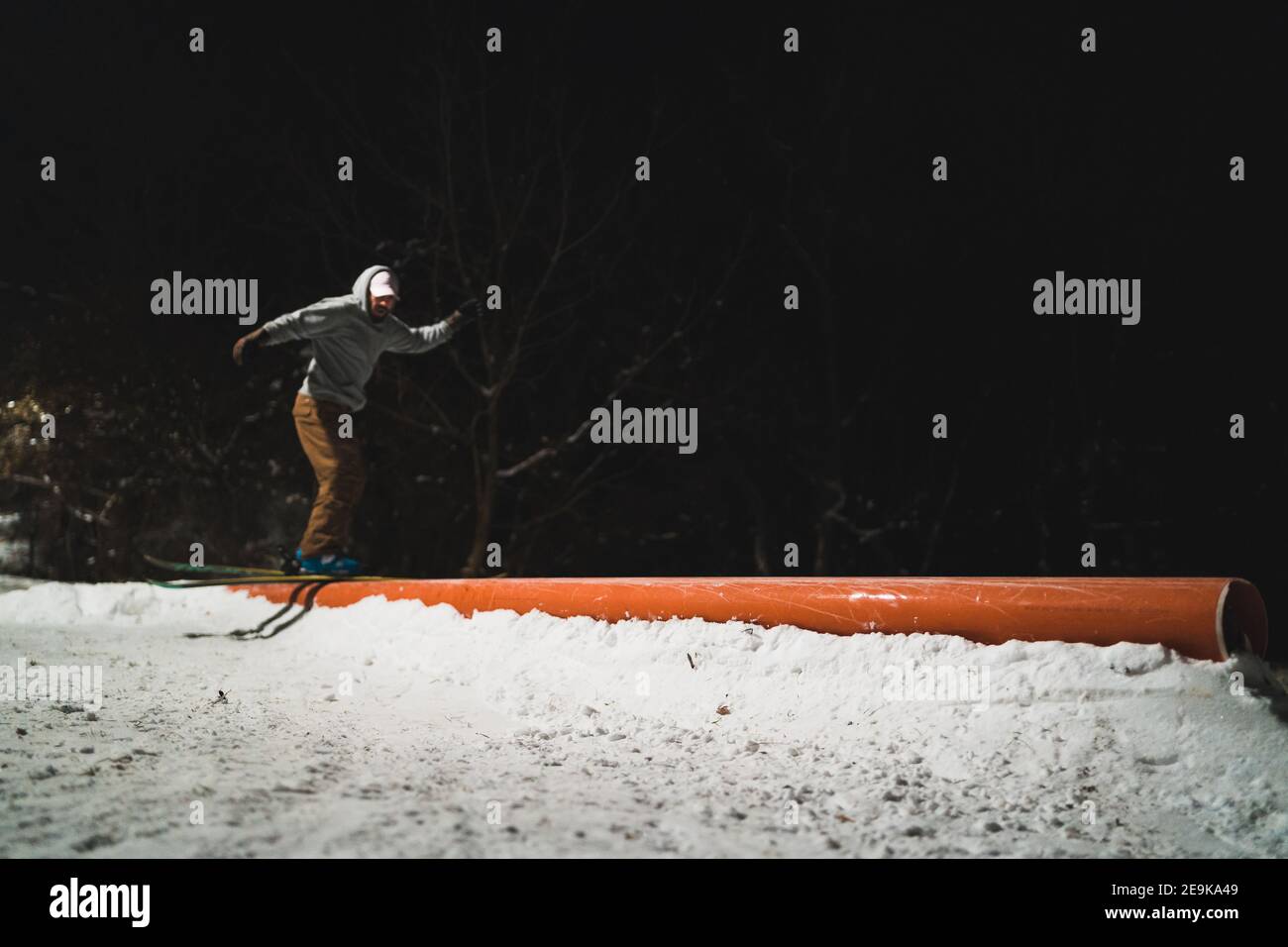 Freestyle skier doing tricks on rails in city park Stock Photo