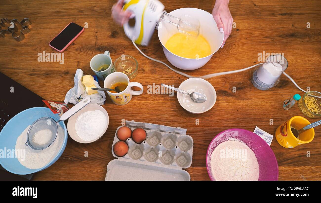 Mixing cookie's dough with a hand mixer at home, top view Stock Photo