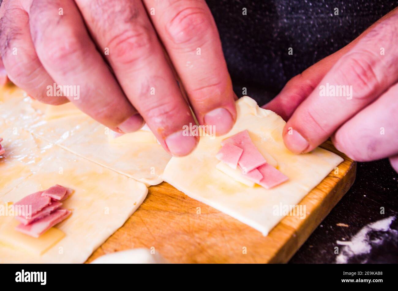 preparation of homemade savory snacks with puff pastry, mortadella