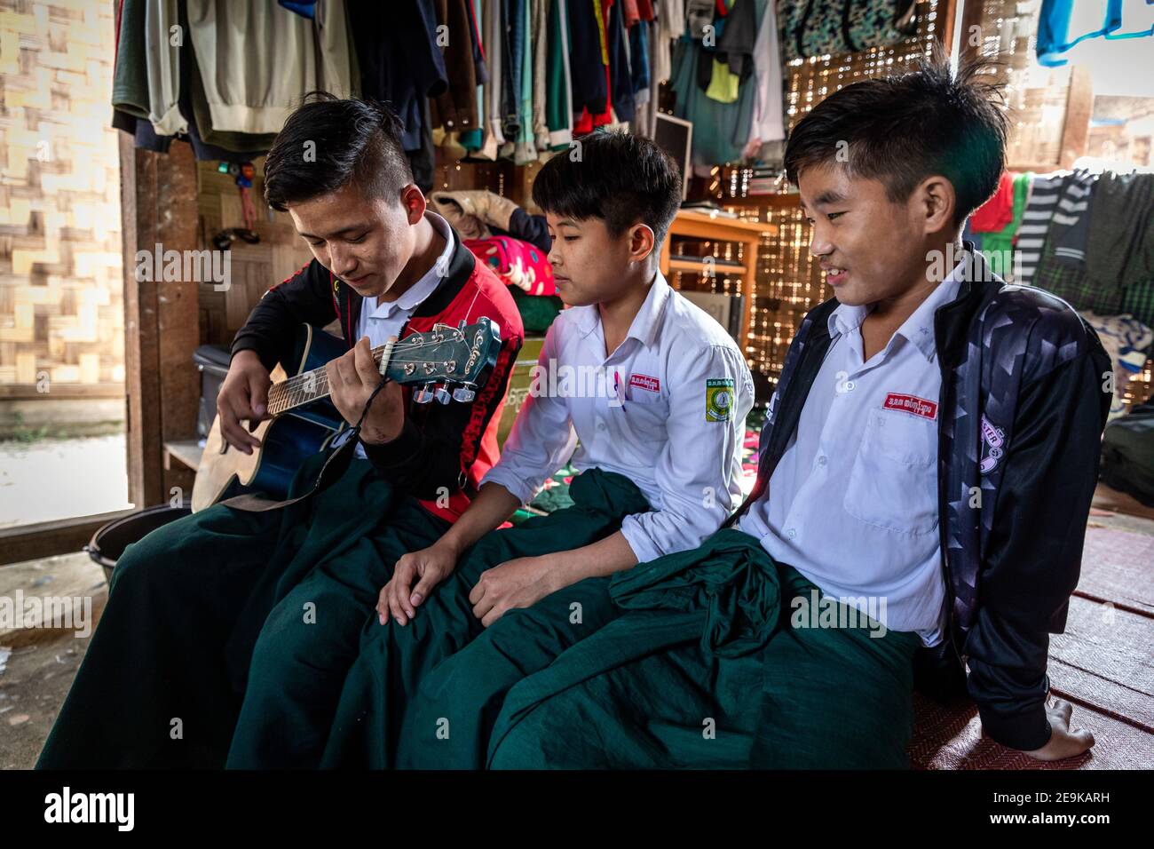 The students, most of whom are orphans who fled the civil war, come to their Chinpwi Education Boarding School in Myikyina, Myanmar, during their lunch break. Stock Photo