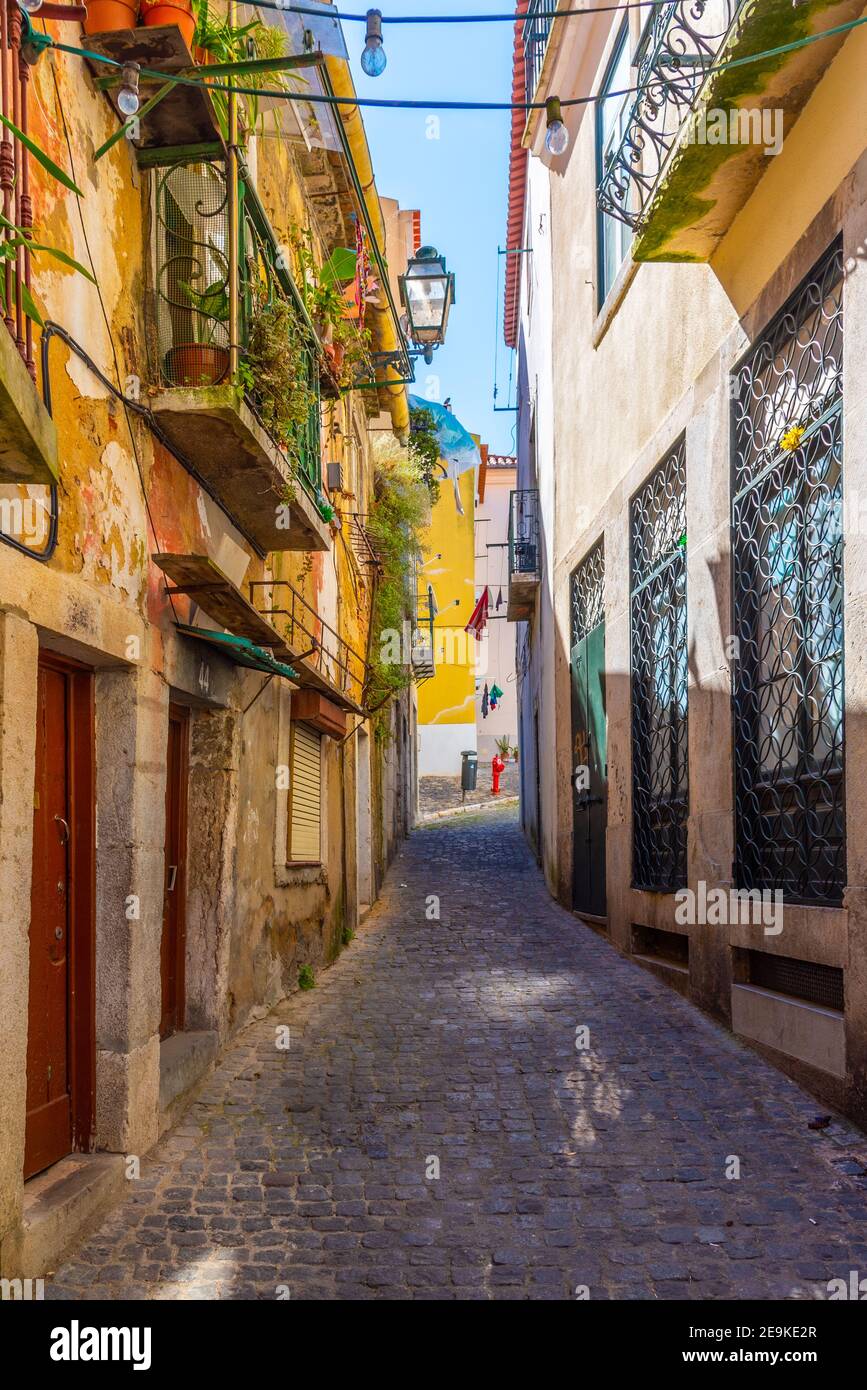 narrow street at Alfama district in Lisbon, Portugal Stock Photo - Alamy