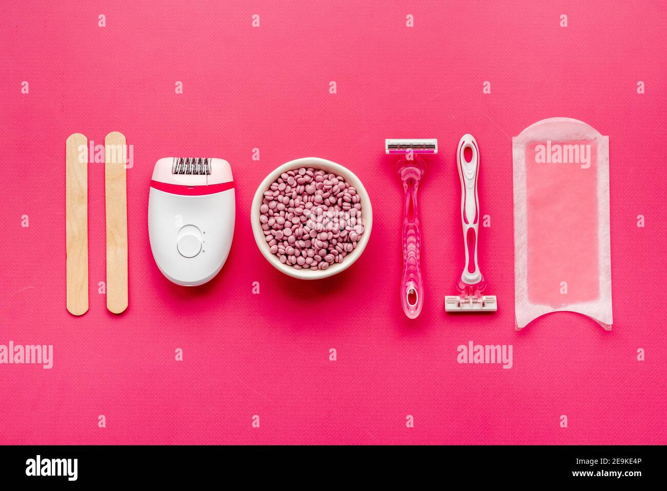 Set of epilation means - epilator with wax strips, razor and flowers. Top  view Stock Photo - Alamy