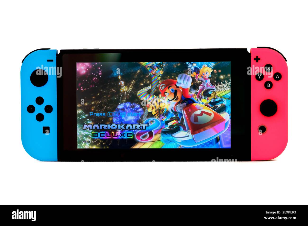 A Nintendo Switch handheld video games console. The console is shown in handheld mode, controllers attached and Mario Karts 8 splash screen visible Stock Photo