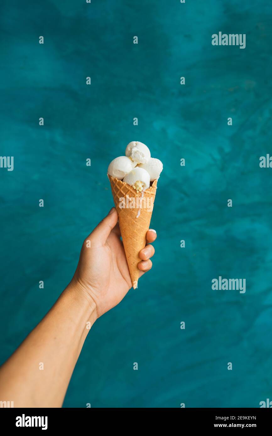 Ice cream in hand during the hot day Stock Photo Alamy