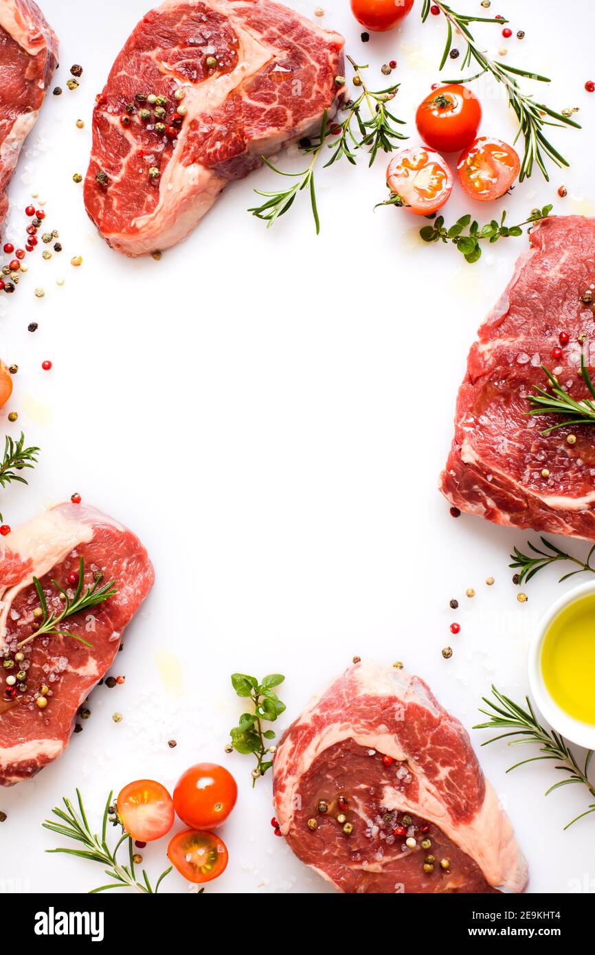 cooking Ribeye steak with spices, cherry tomatoes and olive oil Stock