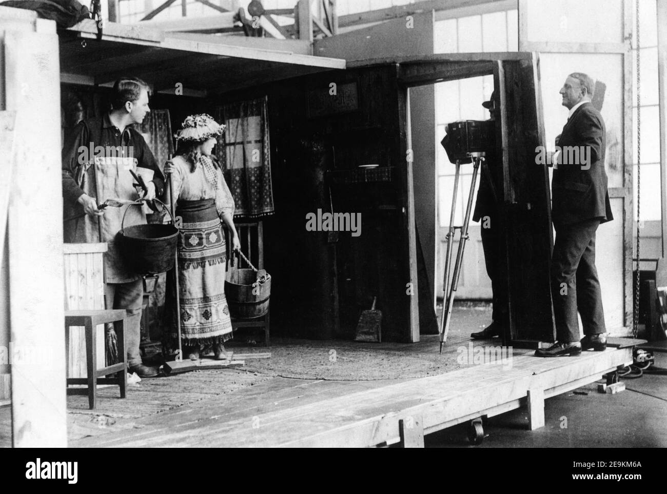 MATT MOORE and MARY PICKFORD  being directed by MAURICE TOURNEUR on set candid during filming of THE PRIDE OF THE CLAN 1917 director MAURICE TOURNEUR cinematographers Lucien N. Andriot and John van den Broek  editor / assistant director Clarence Brown Mary Pickford Company / Artcraft Pictures Corporation Stock Photo