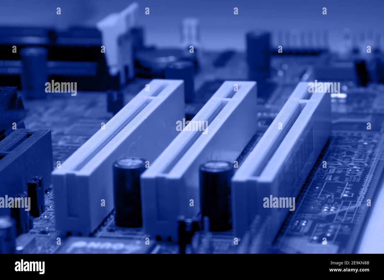Detail of printed circuit board an PCI slots, old motherboard in blue colour Stock Photo
