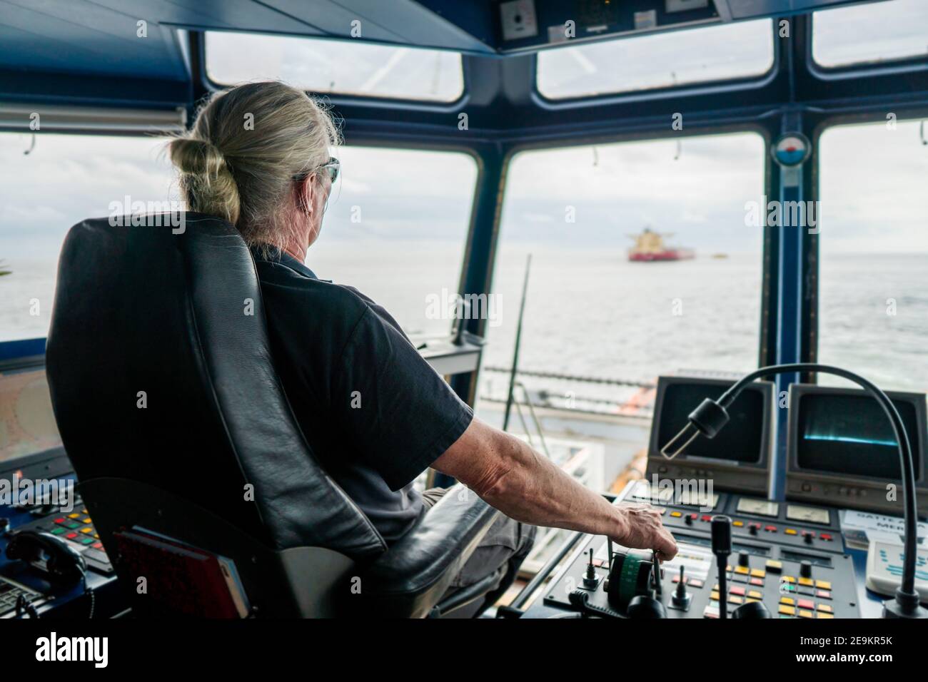 Captain of deck Officer on bridge of vessel or ship during navigaton watch at sea Stock Photo