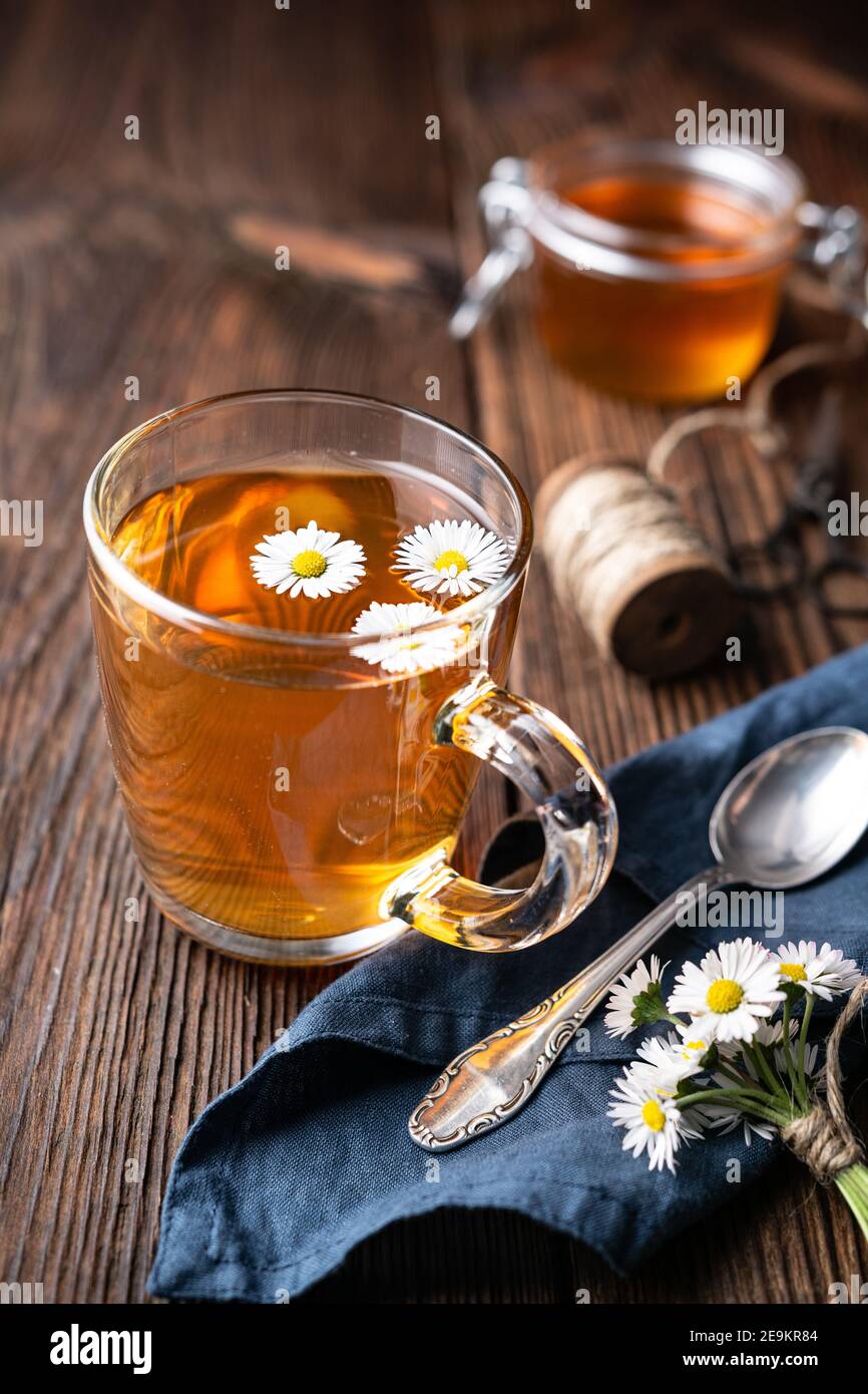 Herbal medicine for respiratory health, a cup of daisy tea with honey