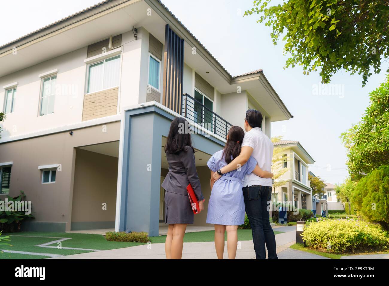 Asian woman Real estate broker agent showing a house detail in her file