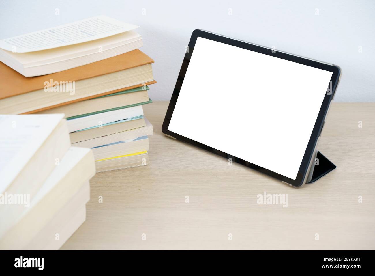 Digital tablet with empty white display on wooden table Stock Photo