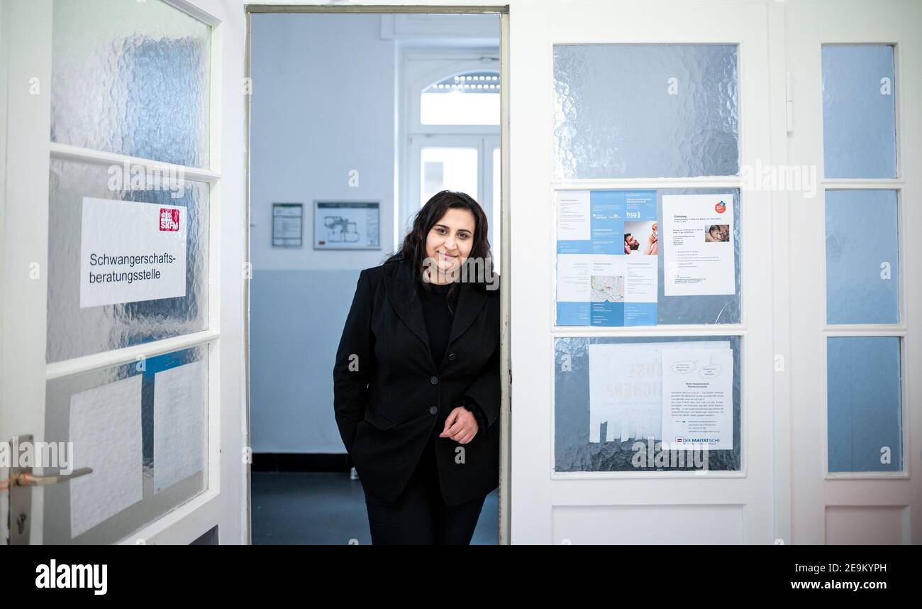 Bochum Wattenscheid, Germany. 05th Feb, 2021. Family helper Jihan Khodr from the Sozialdienst Katholischer Frauen und Männer Wattenscheid e.V. (SKFM). (SKFM) stands in the entrance to the offices in Wattenscheid. Khodr has spoken to Chancellor Merkel about the problems of families through and during the lockdown as part of a virtual civil dialogue. Credit: Fabian Strauch/dpa/Alamy Live News Stock Photo