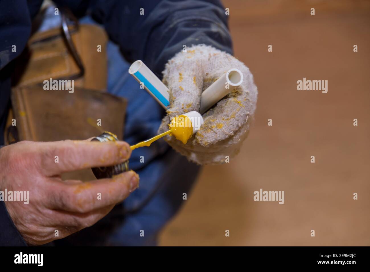 Gluing parts of a pvc water pipe using cement glue assembly