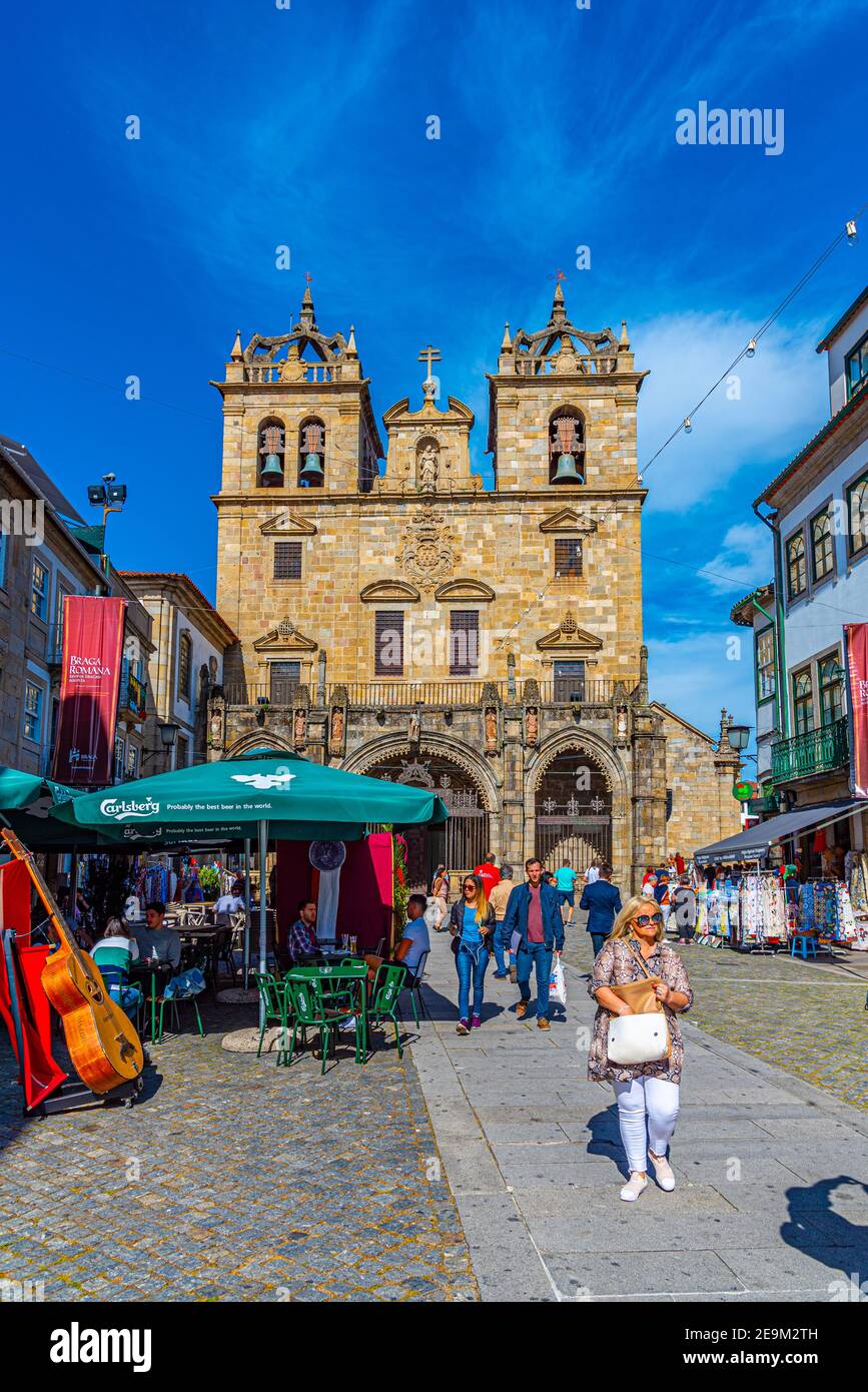 BRAGA, PORTUGAL, MAY 23, 2019: People are strolling on a street leading to the old cathedral in the historical center of Braga, Portugal Stock Photo