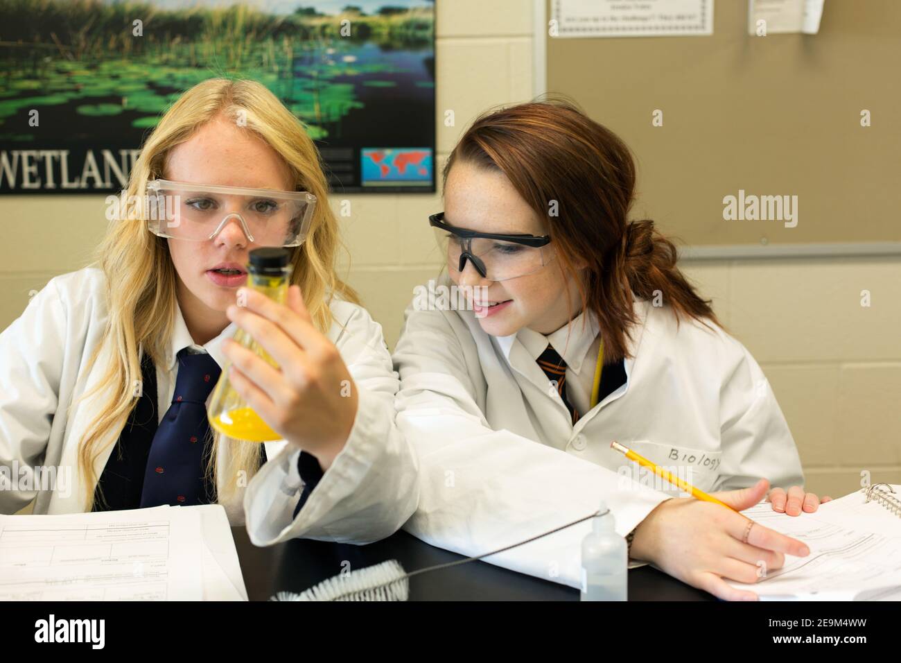 Two teenage female students performing a science experiment Stock Photo