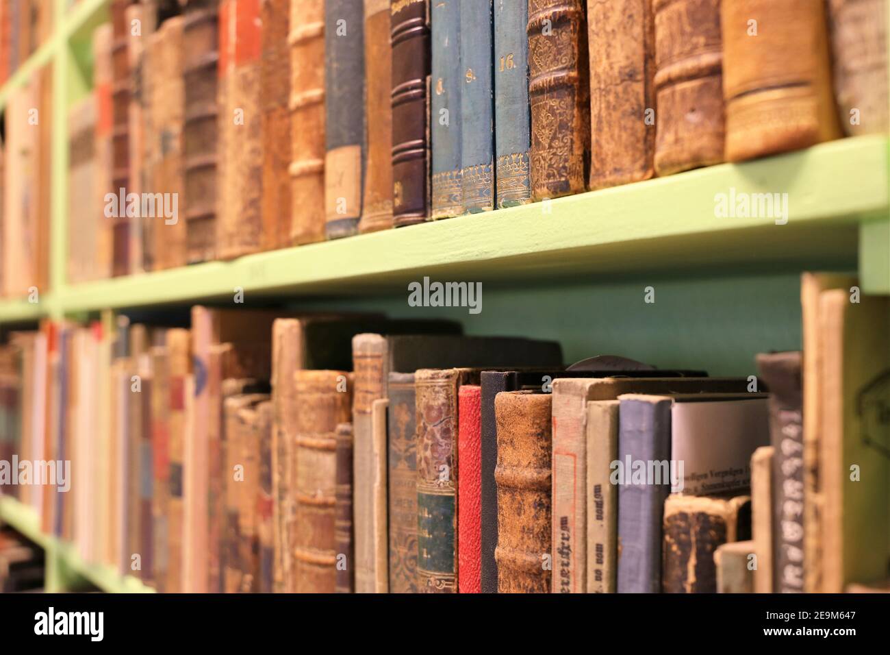 Books on a shelf in an antique shop Stock Photo Alamy