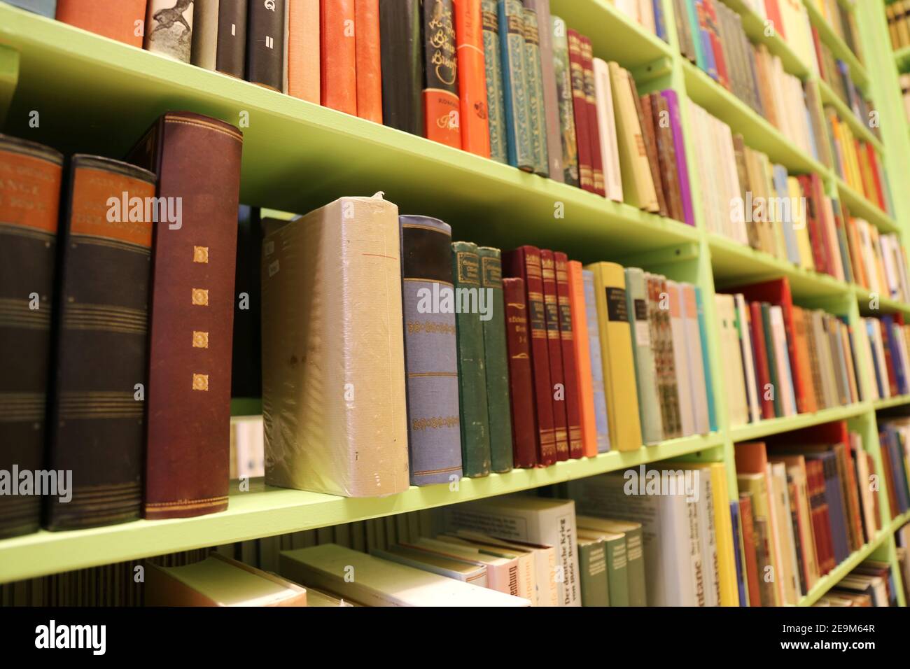 Books on a shelf in an antique shop Stock Photo - Alamy