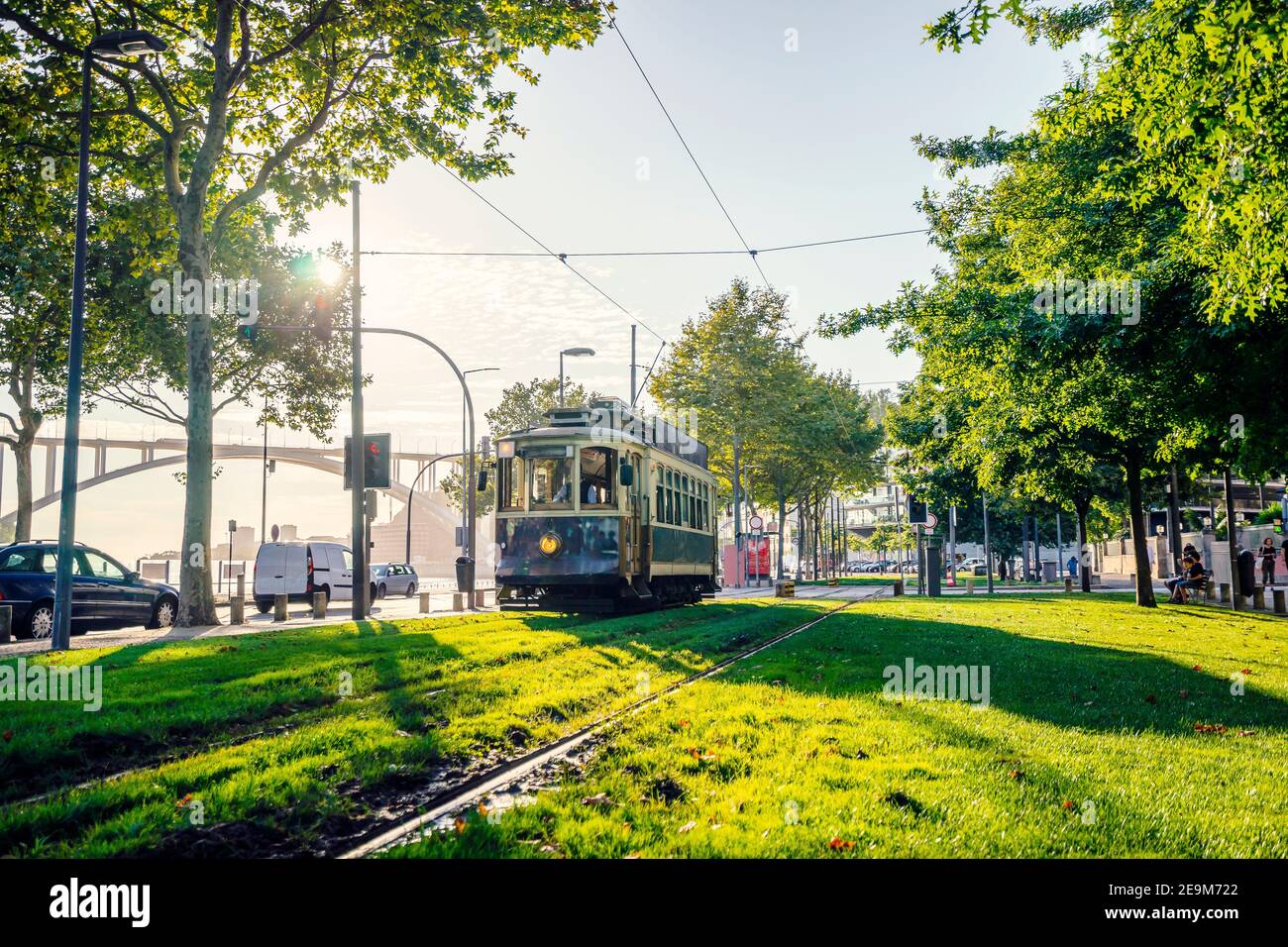 Vintage tram heading city center of Porto by sunset, Portugal Stock Photo