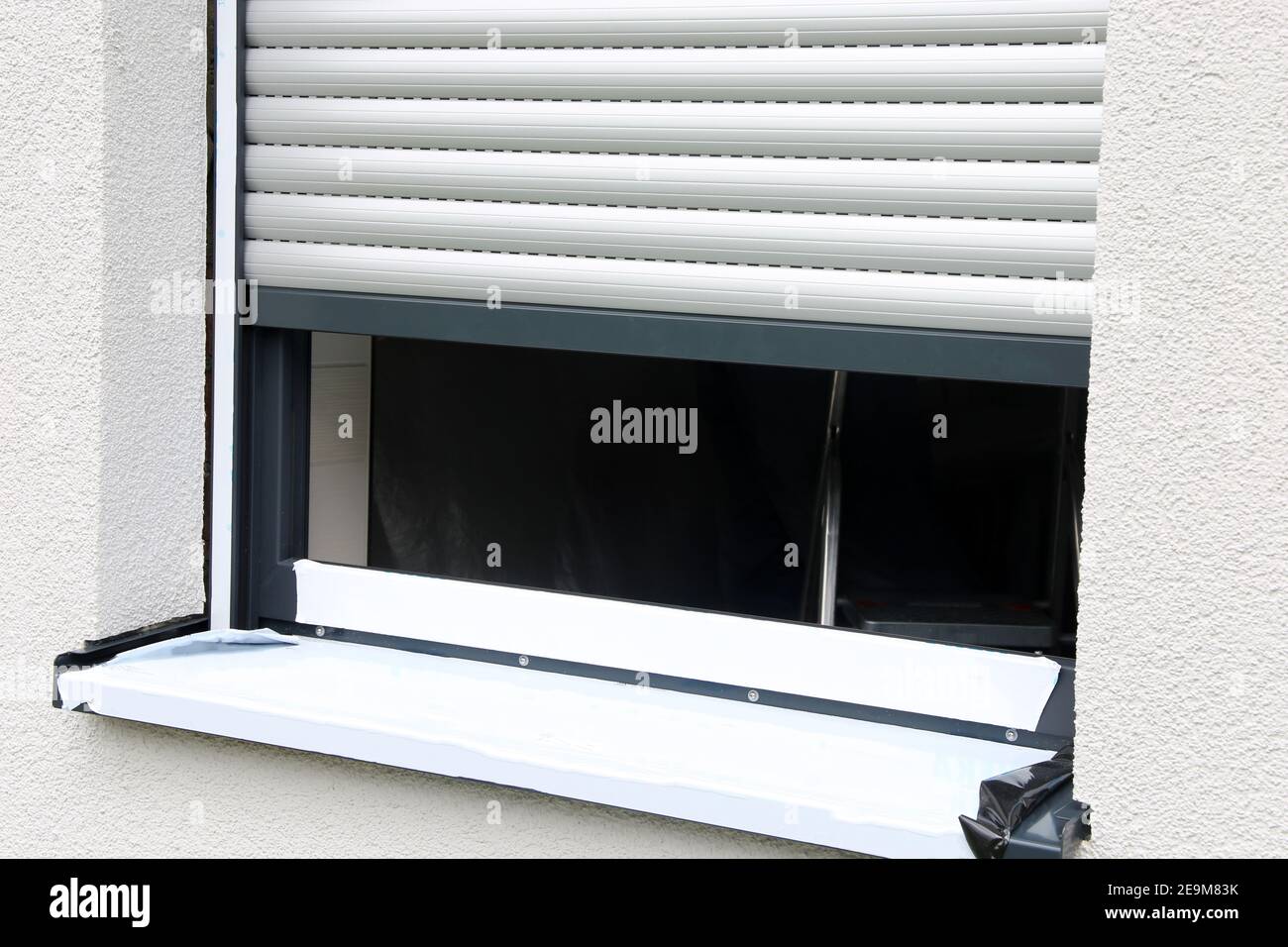 Newly installed window with roller shutter Stock Photo
