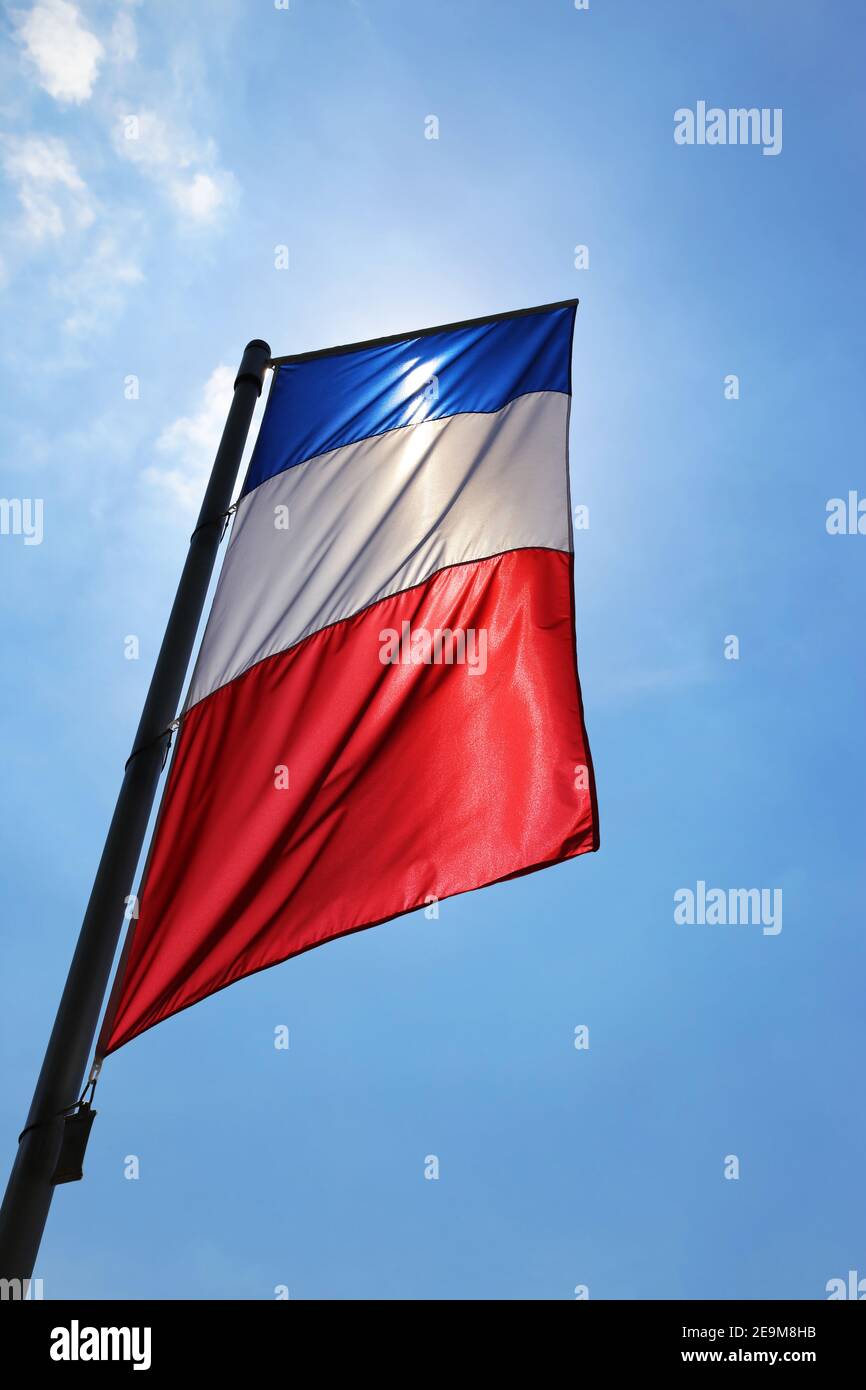 French flag in front of a blue sky Stock Photo Alamy