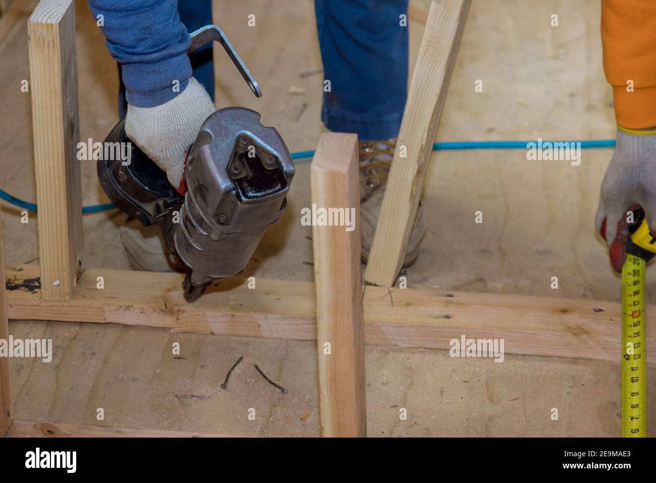 Wood beam construction on air nail gun pneumatic framing nailer in the