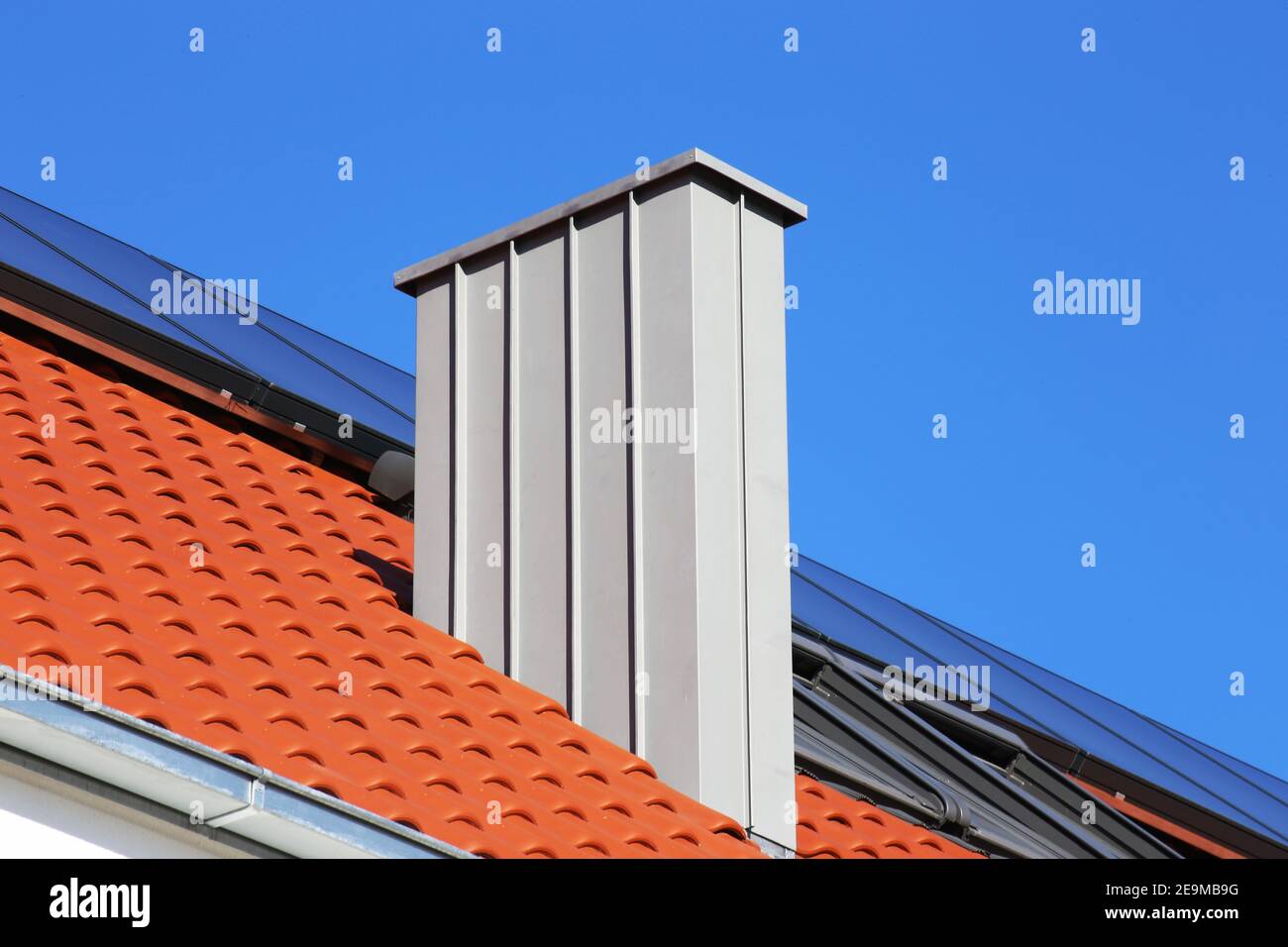 Chimney with stainless steel cladding on a newly covered roof Stock ...